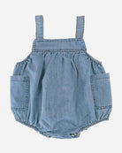 Back of the denim bubble romper showing the straps and gathered bubble shape