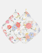 Two Toshi muslin washcloths with hanging loops, one in the Wild Garden print and one in a larger coral, pink and lilac floral