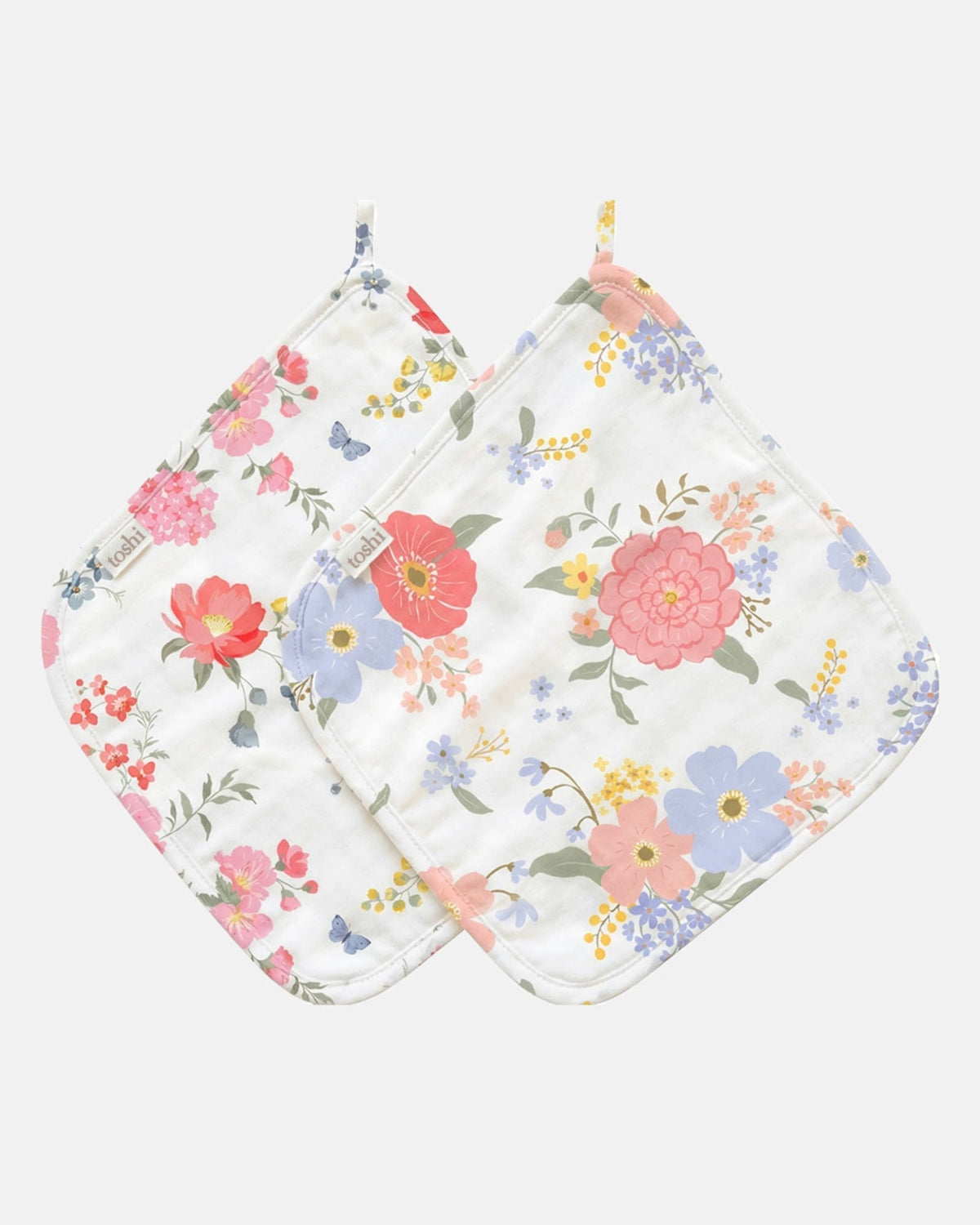 Two Toshi muslin washcloths with hanging loops, one in the Wild Garden print and one in a larger coral, pink and lilac floral