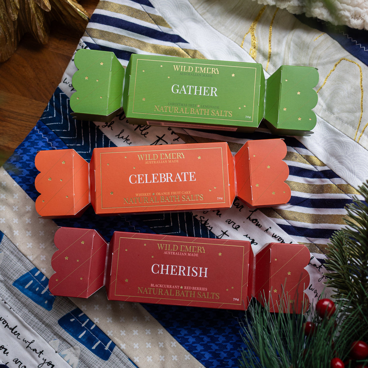 The three bon bons from the set, green Gather, orange Celebrate and red Cherish, on a patchwork quilt.