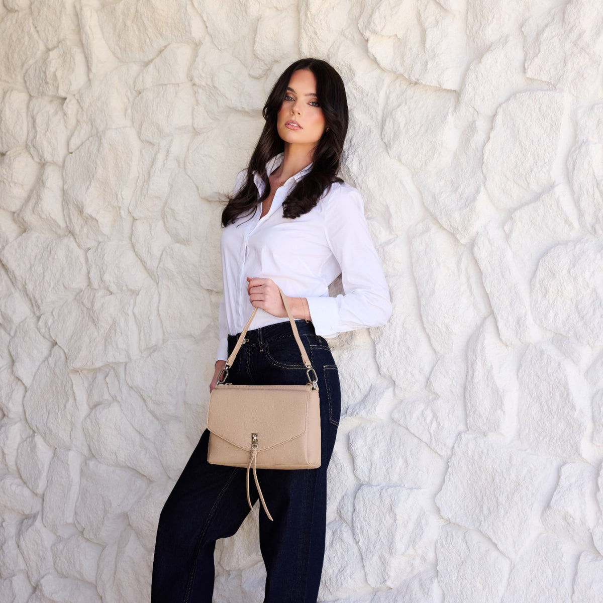 The same woman holding the biscuit bag by its shoulder strap at her hip.