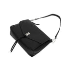 The black bag lying flat, with the shoulder strap looped behind.