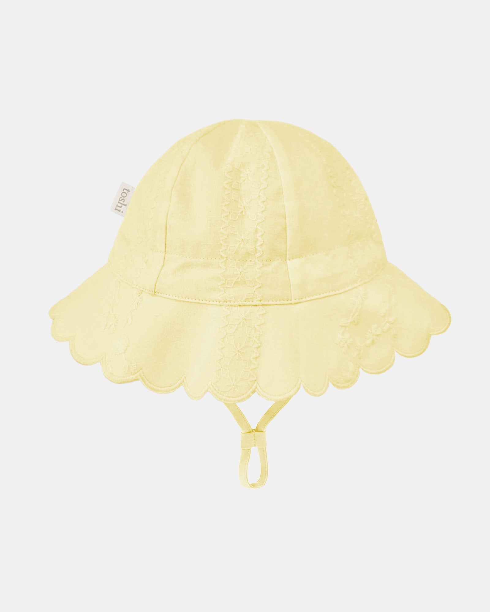 Plain side of the lemon Florence sunhat, opposite the toggle, showing the embroidered panels and Toshi label