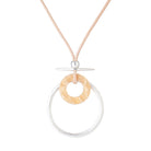Silver-tone ring and woven-look circle pendant on a blush cord