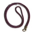 A crossbody phone lanyard coiled in a loop, the cord densely set with small fuchsia pink sparkling stones, finished with a gold-tone clasp ring.