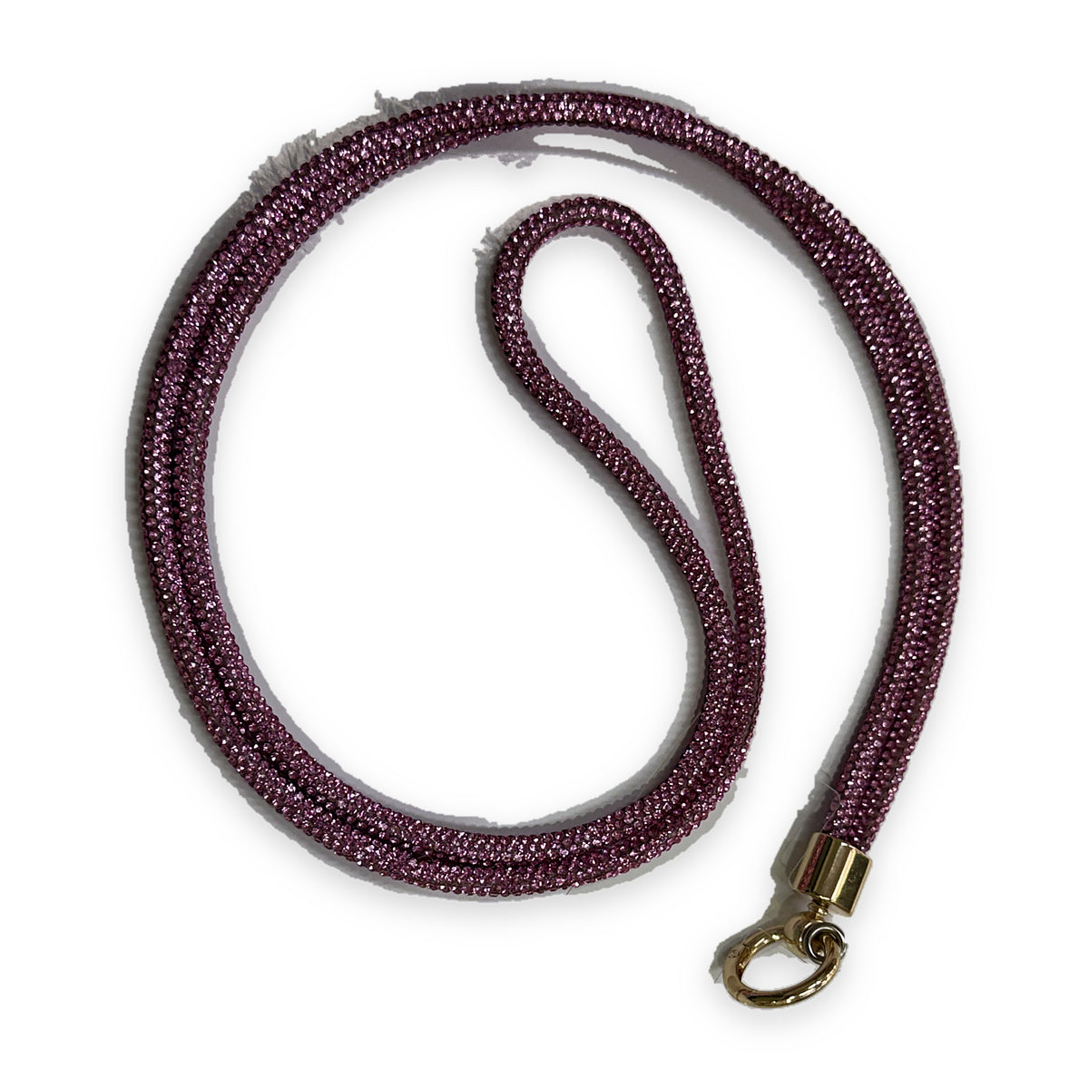 A crossbody phone lanyard coiled in a loop, the cord densely set with small fuchsia pink sparkling stones, finished with a gold-tone clasp ring.