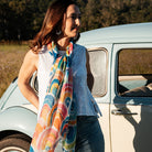 Bow scarf worn draped beside a vintage car