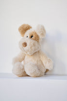 The dog rattle sitting on a white ledge against a pale wall.