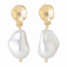 Gold-tone clip-on earrings with a hammered disc and baroque pearl drop