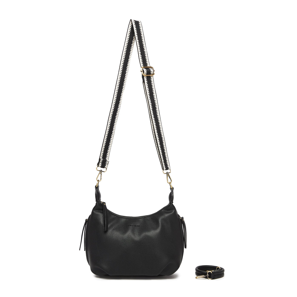The black bag on a black and cream patterned cotton strap, with the black strap coiled beside it.