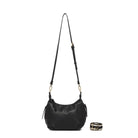 The black bag on its long black cross body strap, with the patterned cotton strap coiled beside it.