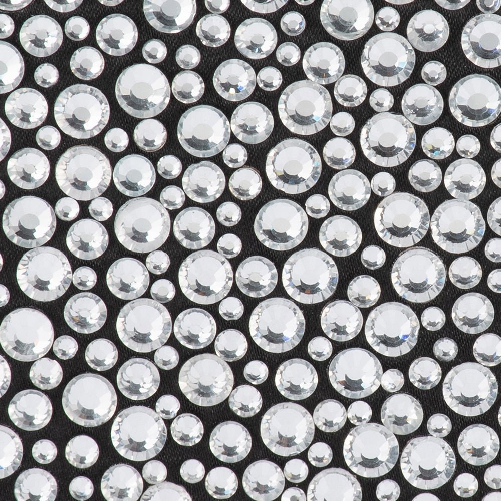 Close-up of silver glass crystals in mixed sizes on black satin