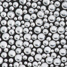 Close-up of silver glass crystals in mixed sizes on black satin