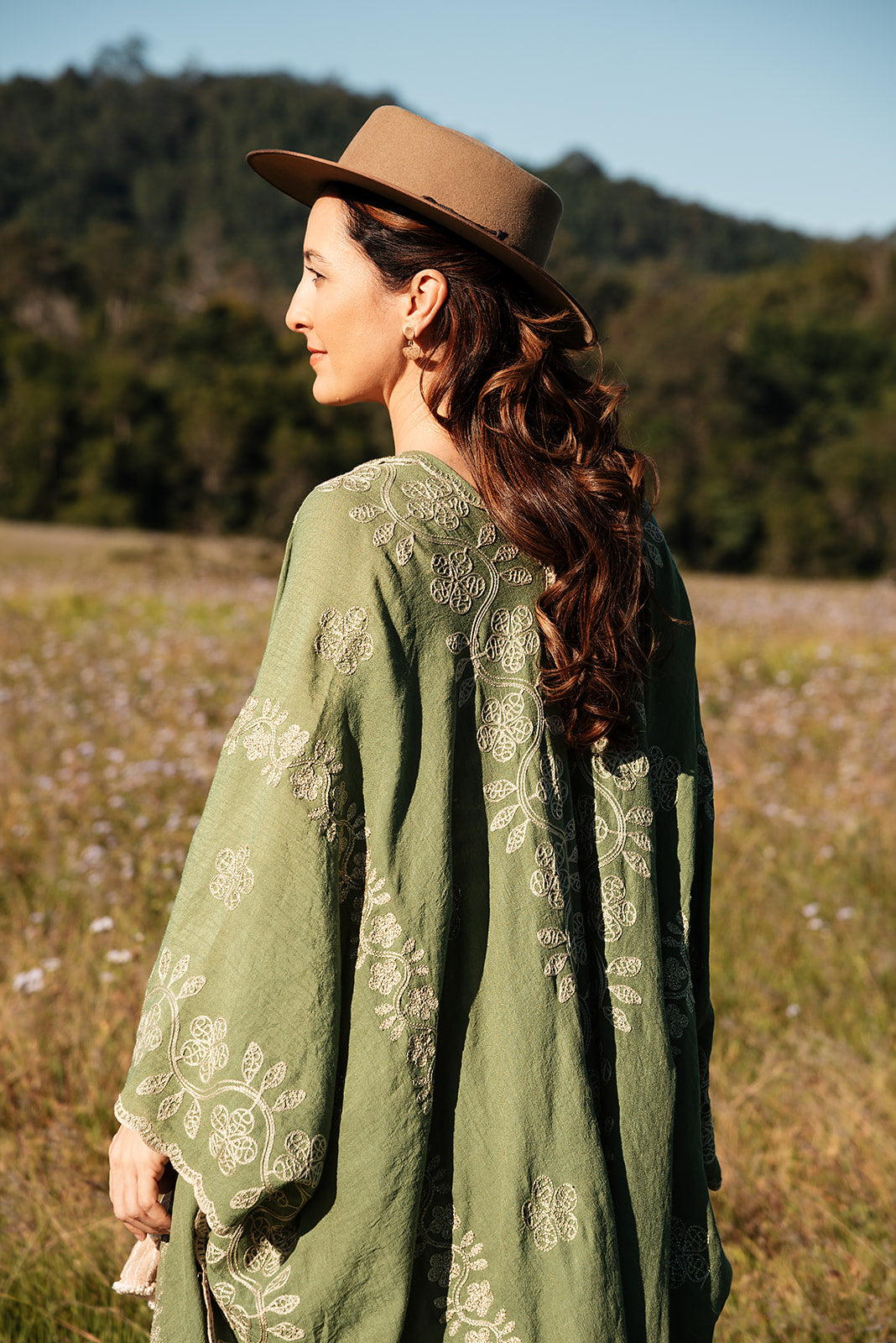 Back view of the green garland cover-up worn outdoors