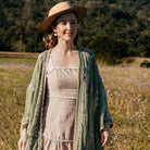 Green garland cover-up worn in a field with a straw hat