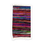 One handwoven chindi rug laid flat, densely striped in pink, purple, red, teal and black recycled fabric, with cream fringing across both short ends.