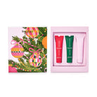 Huxter Hand Cream Trio box lid with Christmas baubles and pine, beside the open box holding red, green and pale pink tubes.
