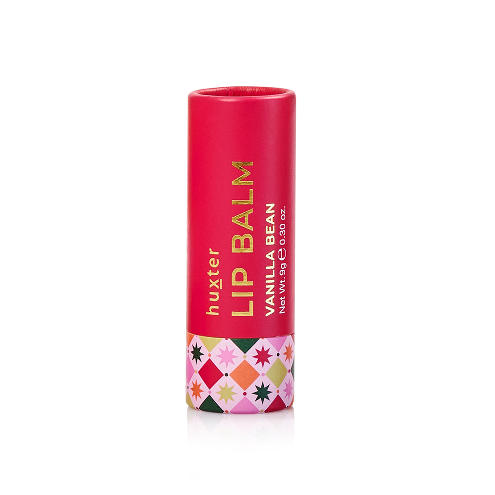 Red 9 g Huxter Vanilla Bean lip balm tube with a band of Christmas stars.