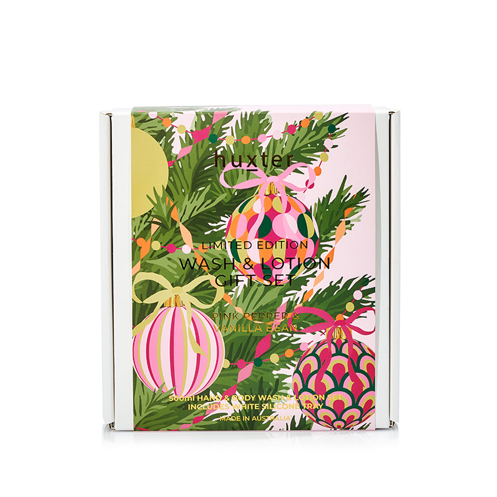 The printed sleeve of the Huxter limited edition Wash & Lotion Gift Set, pink with Christmas baubles, pine and ribbon.