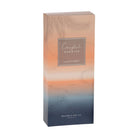 The Coastal Sunrise gift box on its own, peach fading to navy with a palm print.