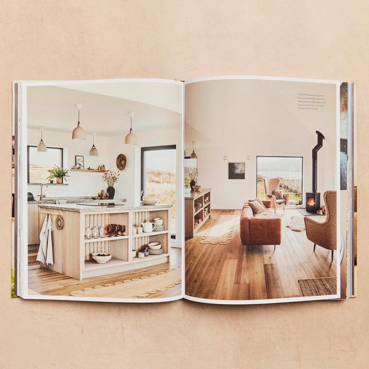 Cocoon open at a spread of a timber kitchen and a living room with a wood heater.