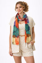 Colour Splash Umbrella cotton modal scarf worn draped around the neck with a cream outfit