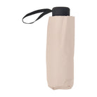 Oyster beige folded umbrella standing upright with a black handle and wrist strap.