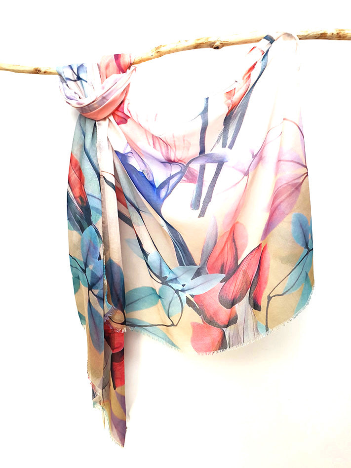Coral and Teal Floral cotton viscose scarf knotted over a branch, coral, teal and blue painted flowers on a white to sand ground