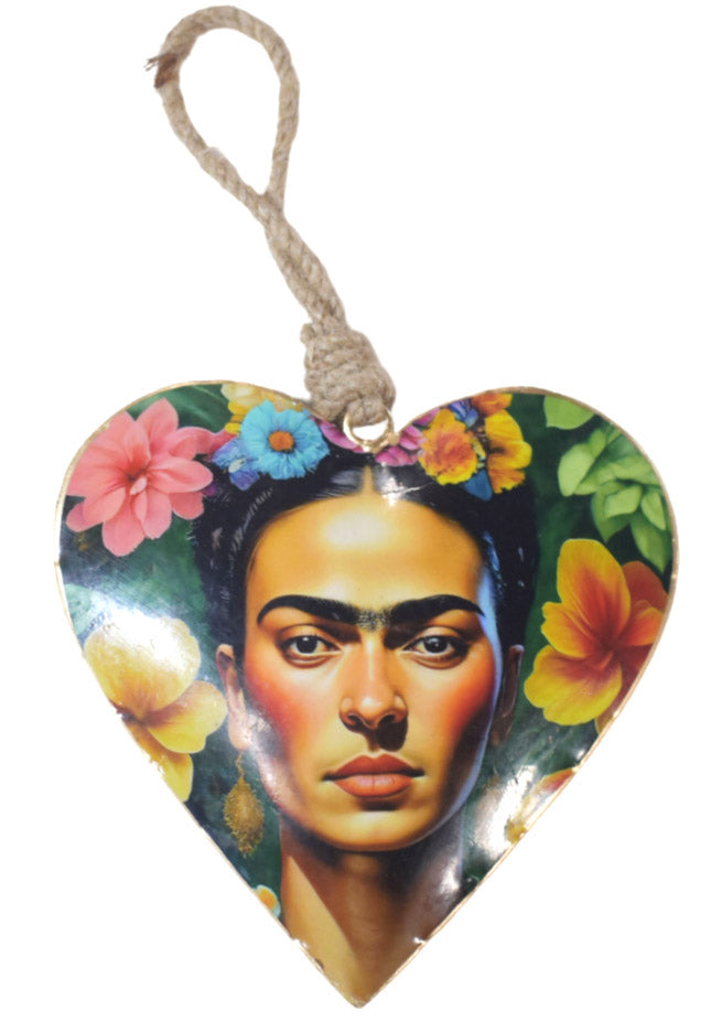 Heart-shaped hanging decoration printed with Frida Kahlo among pink, yellow and orange hibiscus on green, hung from a thick twisted rope loop