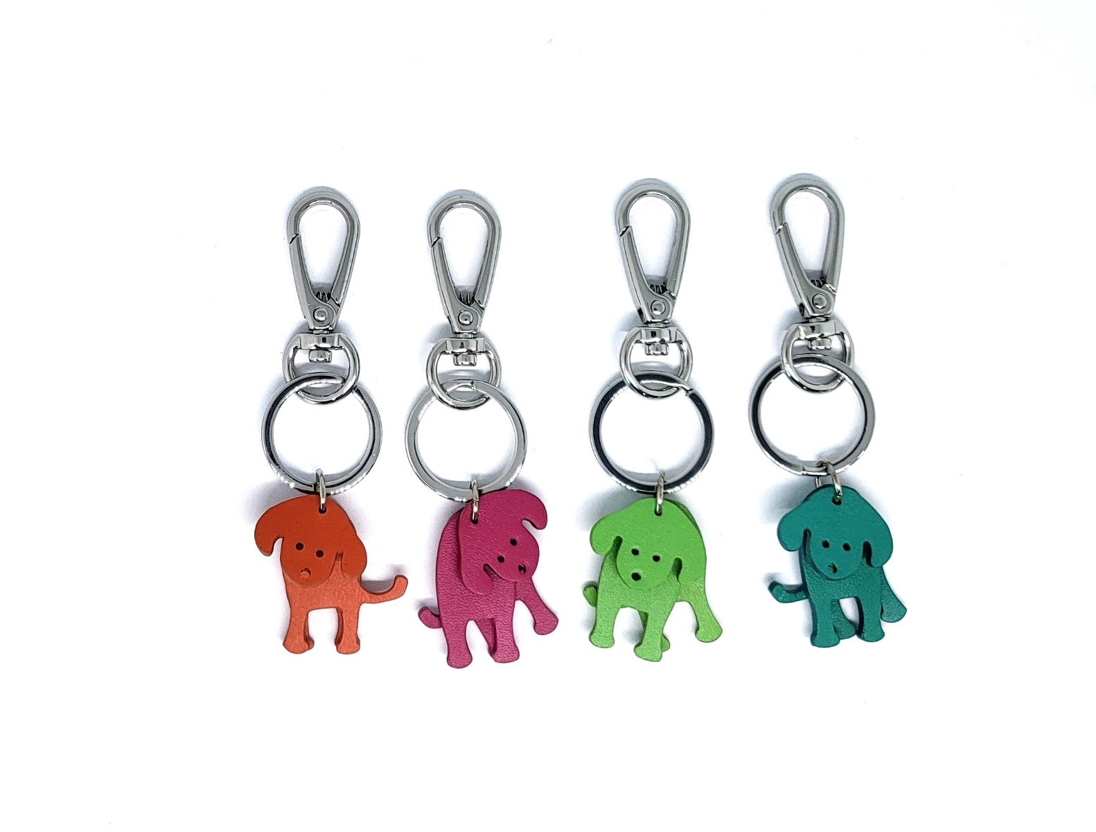 Four leather puppy keyrings in orange, pink, green and teal with silver clips