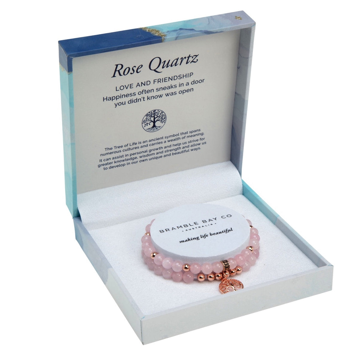 Two rose quartz bead bracelets with rose gold spacers and a Tree of Life charm, in an open blue marble gift box