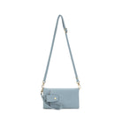 The pale blue wallet hanging from its long cross body strap, with the wrist strap attached.