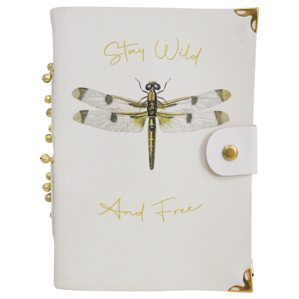 Cream leather notebook with a dragonfly print, Stay Wild And Free in gold script, a press-stud tab, brass corners and gold beads on the spine