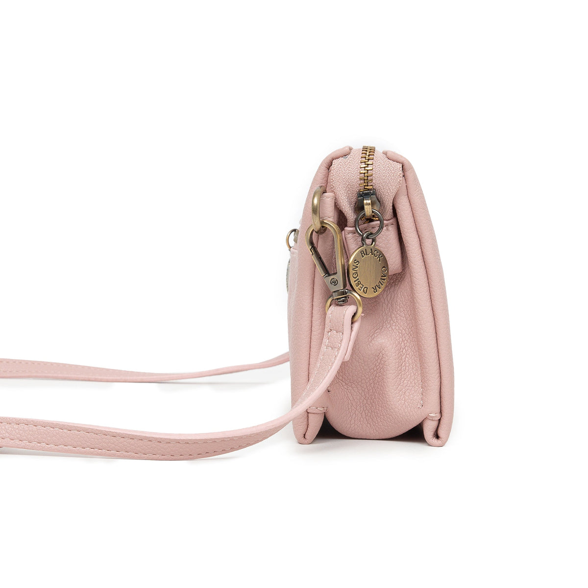 Side view of the pink bag, showing its depth and a round charm.