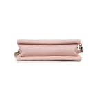 The pink bag from below, showing its flat base.