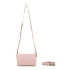 The pink bag on its slim adjustable strap.