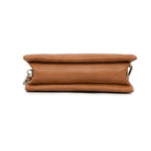 The tan bag from below, showing its flat base.