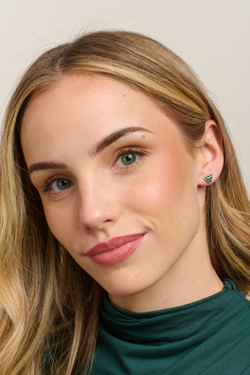 Model in a green top wearing the green gingham heart studs
