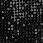 Close-up of the black metal mesh catching the light