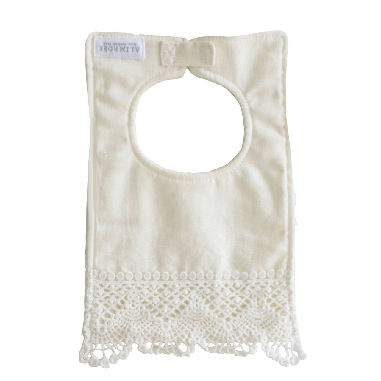 The back of the ivory linen bib with its crochet lace hem, label and neck tab.