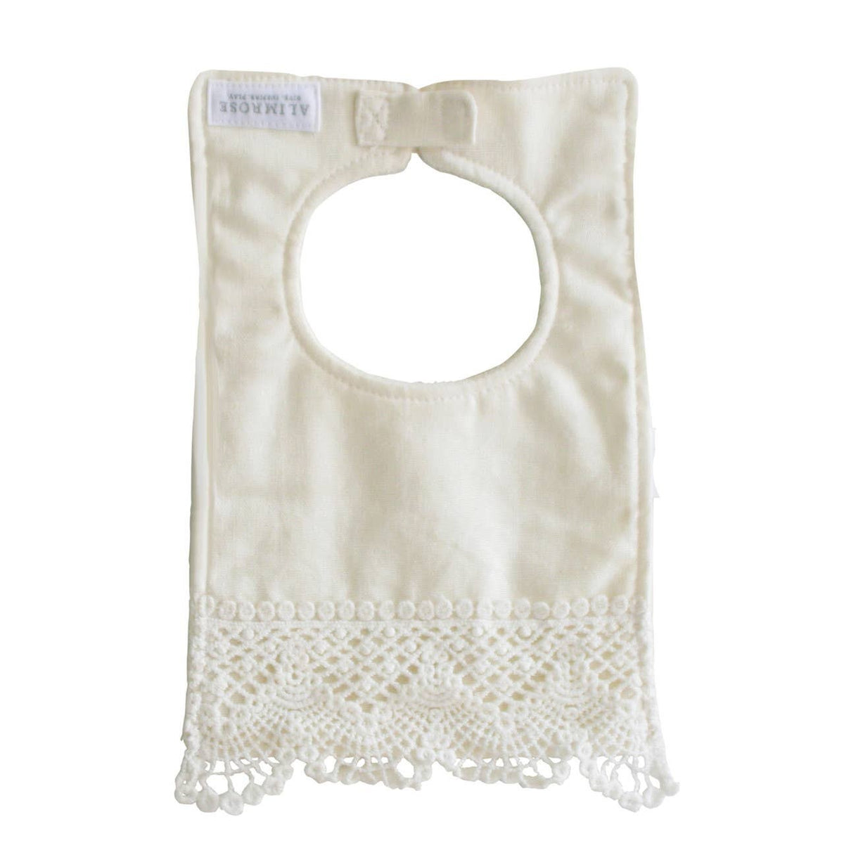 The back of the ivory linen bib with its crochet lace hem, label and neck tab.