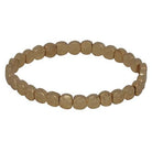 Stretch bracelet of small hammered gold discs.