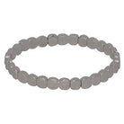 Stretch bracelet of small hammered silver discs.