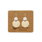 Pair of fish hook earrings, a small brushed silver-tone disc above a larger brushed gold-tone disc, on an Ear Mints card.