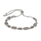 Silver-tone slider bracelet of hammered rectangular links, with a sliding clasp and ball-tipped chain ends.