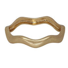 Matte gold-tone bangle with a soft wave running all the way round.