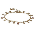 Gold-tone chain bracelet hung with small round discs and pink cubic zirconia drops, with a lobster clasp and extender chain.