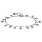 Silver-tone chain bracelet hung with small round discs and green cubic zirconia drops, with a lobster clasp and extender chain.