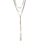 Gold-tone triple-layer necklace of fine herringbone chains, the longest drawn into a Y-shaped lariat with two long tails.