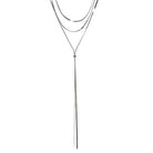 Silver-tone triple-layer necklace of fine herringbone chains, the longest drawn into a Y-shaped lariat with two long tails.